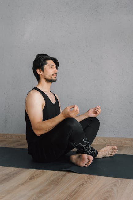 A person sits in a cross-legged meditative pose, with focus on calm breathing